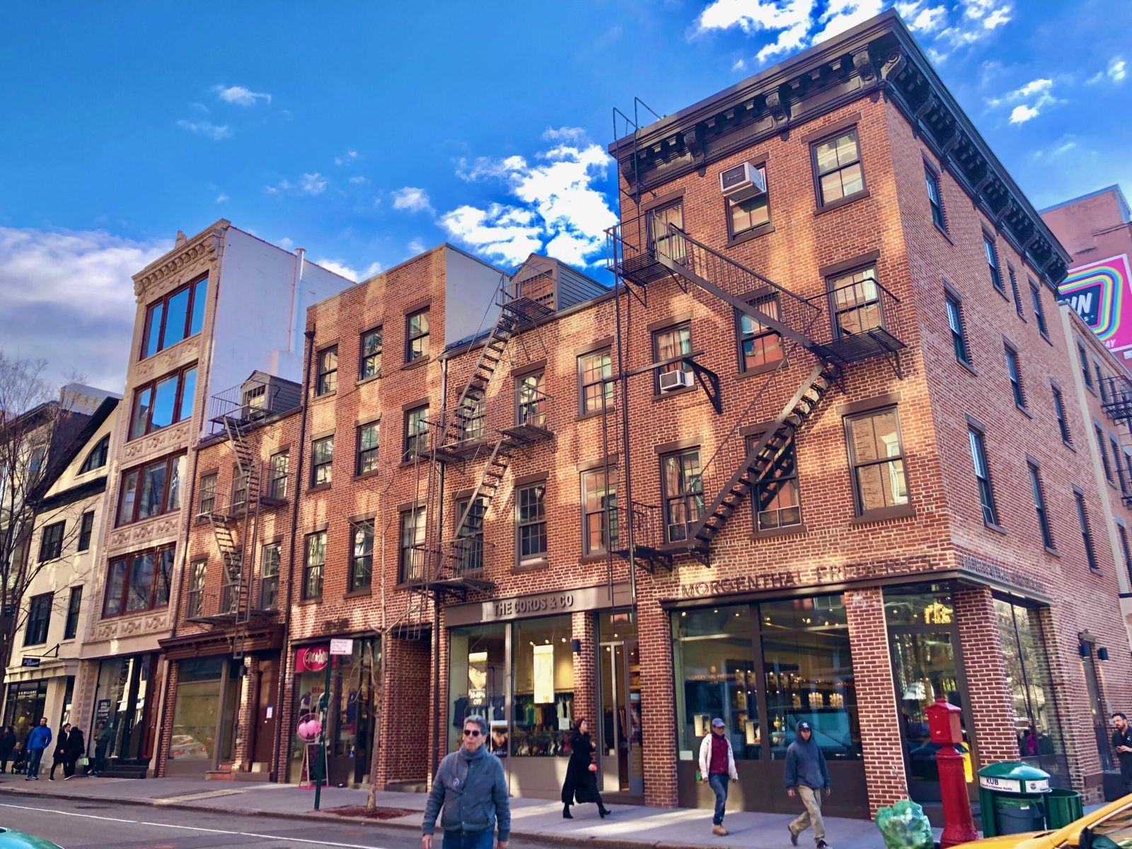 Tenement houses on the lower east side. 2 and 3 stories tall, made form red brick with fire stairs on the outside of each.